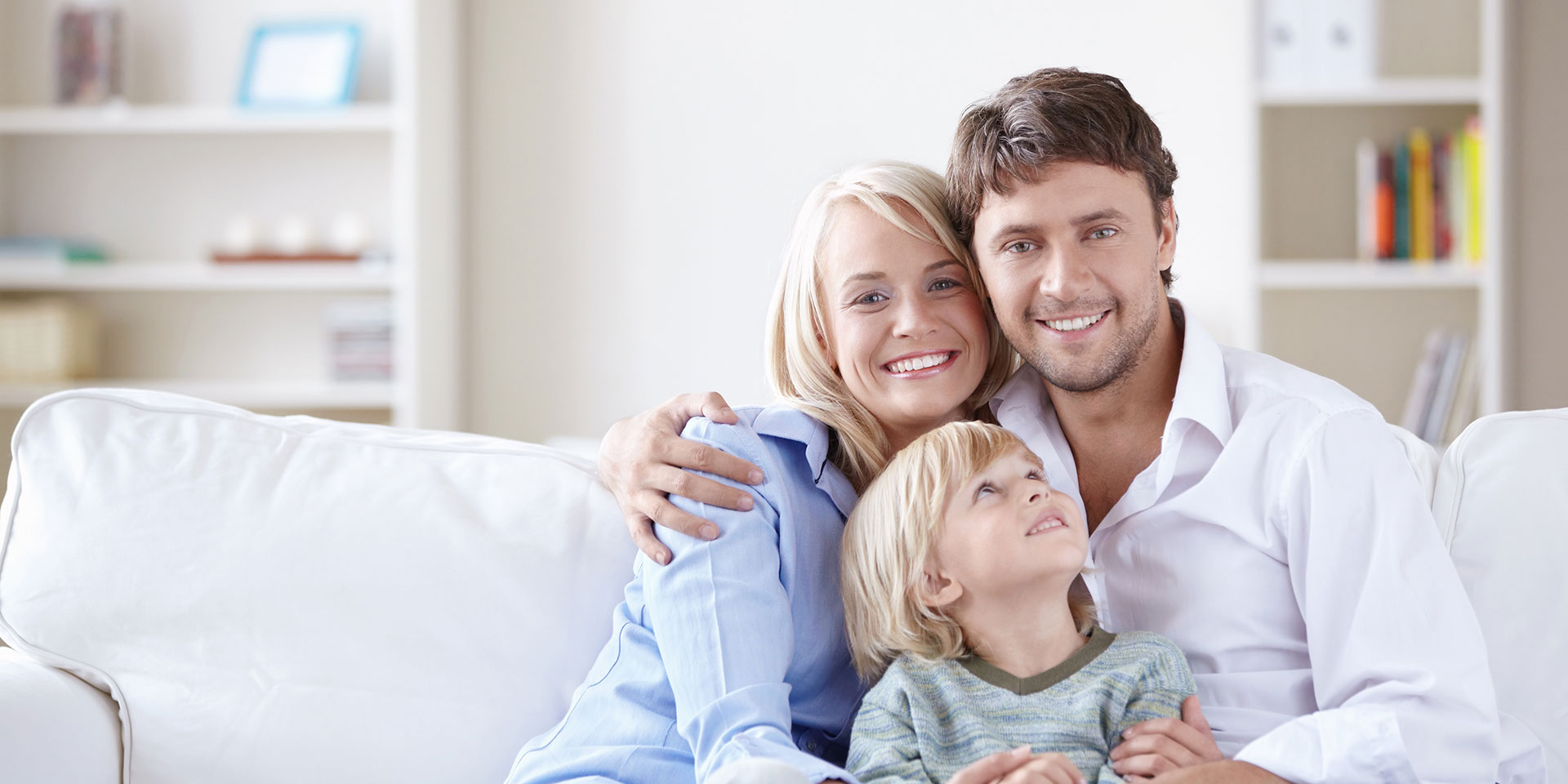 picture of family smiling on couch